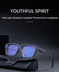 Detail of photochromic rectangle sunglasses with grey frames and blue lenses in a leather case