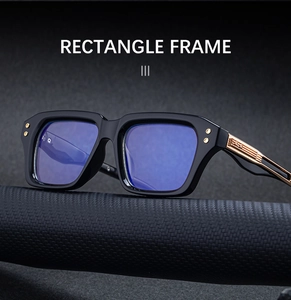 Detailed close-up of rectangle black frame sunglasses with golden hollow temple design