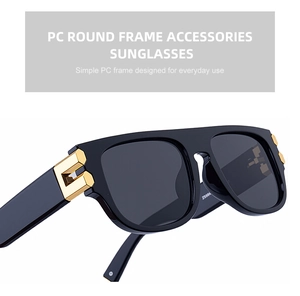 Détail de lunettes de soleil carrées avec monture noire brillante et décors dorés