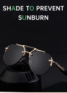 Close-up of steampunk frameless sunglasses showing golden double-bridge and carved metal detail