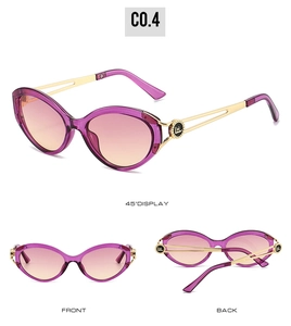 Cat eye sunglasses detail with purple gradient lenses and gold hollowed-out logo temples