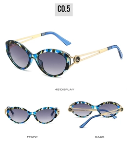 Detailed view of cat-eye sunglasses with marble pattern and hollow metal temple design