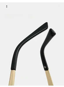 Close-up of black and gold curved mirror legs on cat-eye sunglasses for comfortable wear