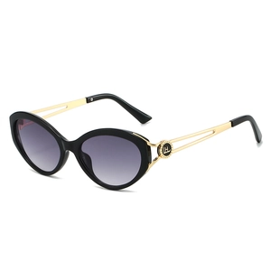 Chic black cat-eye sunglasses with gold hollow temples and purple gradient lenses