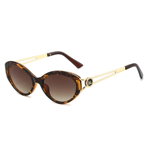 Cat eye tortoiseshell sunglasses with gold hollowed-out temples and gradient brown lenses
