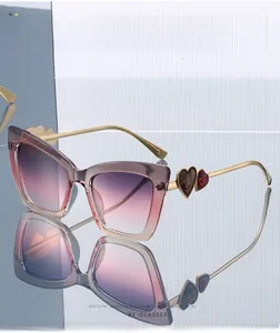 Detail of gold metal temples featuring heart-shaped accents on cat-eye sunglasses