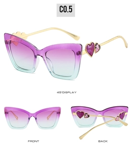 Cat eye sunglasses detail showing purple gradient lenses and gold metal temples with hearts