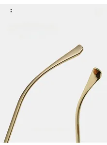 Detail of curved gold metal temples on oversized cat-eye sunglasses for ergonomic comfort