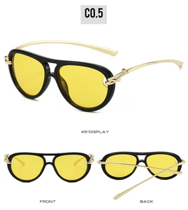 Détail des branches en métal doré noué et verres jaunes sur lunettes aviateur