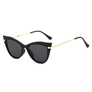 Stylish cat-eye sunglasses with black frame and gold metal temples on white background