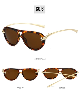 Détail de lunettes aviateur en écaille avec branches à nœuds dorés de style rétro