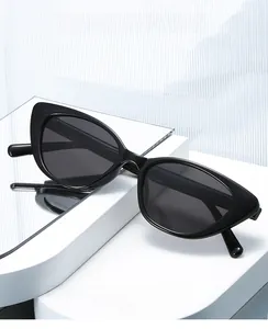 Detail of sleek black cat-eye eyeglass frame with mirror reflection on white stand