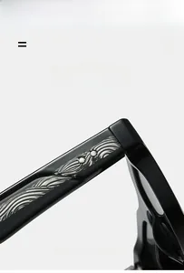 Macro detail of black sunglass temples with silver wave texture and star-shaped accents