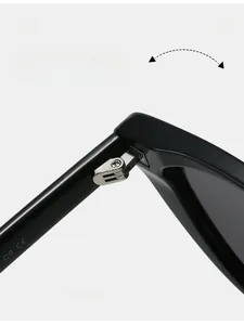 Macro detail of a durable silver metal hinge on classic black cat-eye sunglasses frames