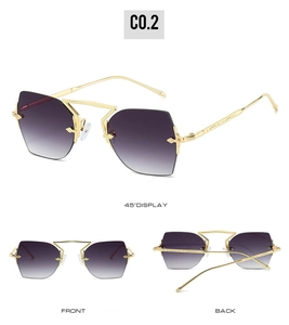 Detail view of rimless geometric sunglasses with purple gradient lenses and gold metal temples