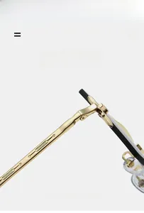Detail of high-quality metal hinge and textured temple on rimless polygonal sunglasses