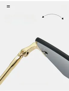 Detail of durable reinforced metal hinge on rimless sunglasses with golden finish
