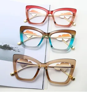 Three cat-eye glasses frames in gradient colors with gold metal temples and heart detail