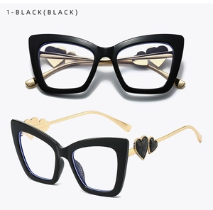 Detailed close-up of cat-eye frames with double heart gold metal temple hinges