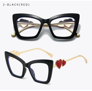Detail view of cat eye anti-blue light glasses with black frames and gold heart temples