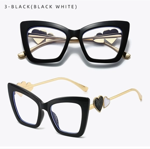 Cat eye glasses featuring black frames and gold metal temples with heart accents