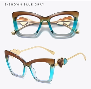 Detail view of cat eye glasses frames with brown blue gray gradient and gold heart temple