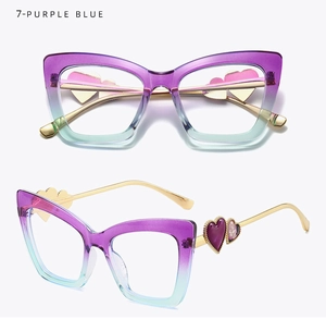 Detail of purple-blue gradient cat eye frames with gold metal temples and heart accents