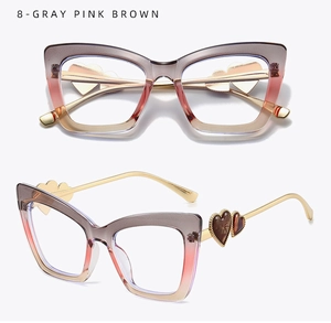 Detail of cat-eye frames with gray-pink-brown gradient and gold heart-shaped metal temples