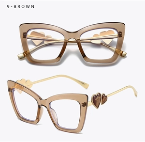 Detailed view of brown cat-eye frames with golden temples and heart-shaped accents