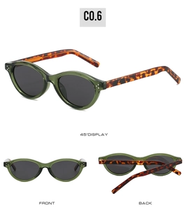 Detail view of oval cat-eye sunglasses with olive green frame and tortoise temples