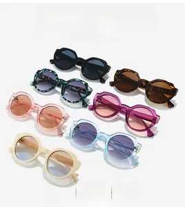Flat lay display of 7 assorted retro round sunglasses in vibrant and transparent colors