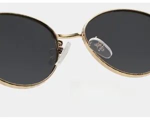 Detail of soft silicone nose pads on gold metal sunglasses for a comfortable fit