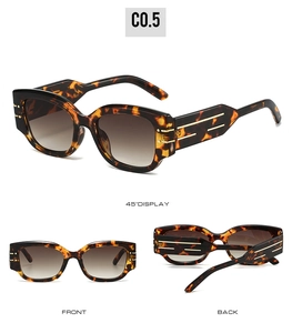 Detail view of tortoiseshell rectangle sunglasses with brown gradient lenses and gold accents