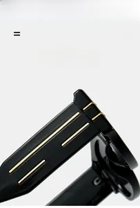 Detail of glossy black eyewear temples featuring sleek parallel gold metal inserts