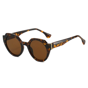 Irregular round tortoise shell sunglasses with brown lenses and golden metal accents