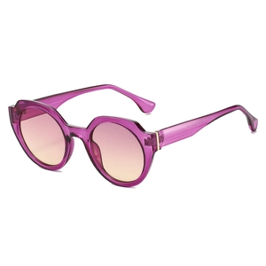 Chic round sunglasses with purple translucent frames and gradient pink lenses shown at 45 degrees