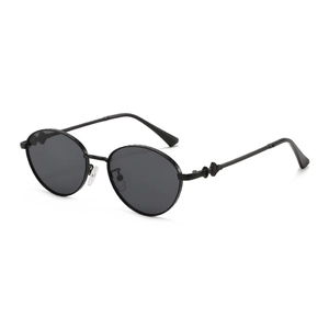 Retro round metal sunglasses with black frames and embossed texture details on temples