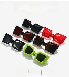 Macro shot of oversized geometric sunglasses in black, red, leopard, and green frames
