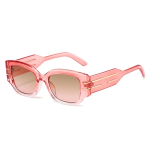 Fashionable pink cat-eye sunglasses with wide gold-detailed temples and brown gradient lenses