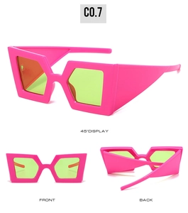 Detailed views of geometric oversized sunglasses with neon pink frames and green lenses