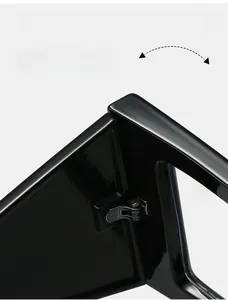 Macro shot of durable metal hinge on stylish wide-leg oversized black sunglasses frame