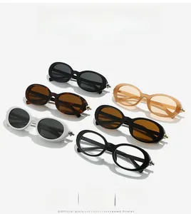 Detail showing various colors of oval sunglasses with metallic ball hinge decoration