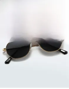 Detail of 9639 metal sunglasses featuring golden frames and dark polygonal lenses
