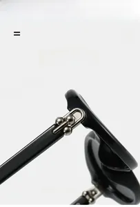 Detailed close-up of durable metal hinge with silver beads on black oval sunglasses