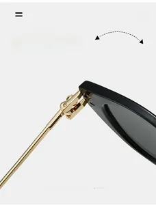 Macro shot of durable golden metal hinge on sleek black cat-eye sunglasses frames