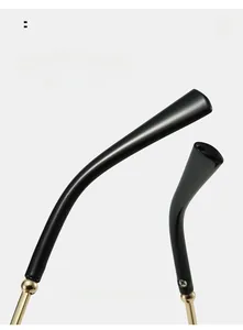 Detail of curved ergonomic black sunglasses legs with elegant gold metallic accents