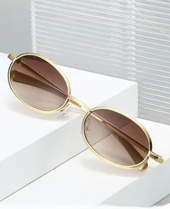 Detail of retro oval metal frame with gradient brown lenses on a white geometric stand