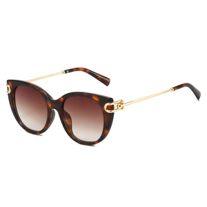Cat eye sunglasses with dark tortoiseshell frames and gold metal temples in a side view