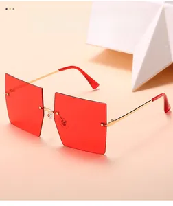 Detail view of red rimless square sunglasses with elegant gold metal temples and accents