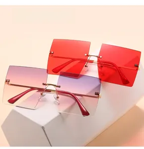 Detail of oversized rimless square sunglasses with red and gradient purple lenses